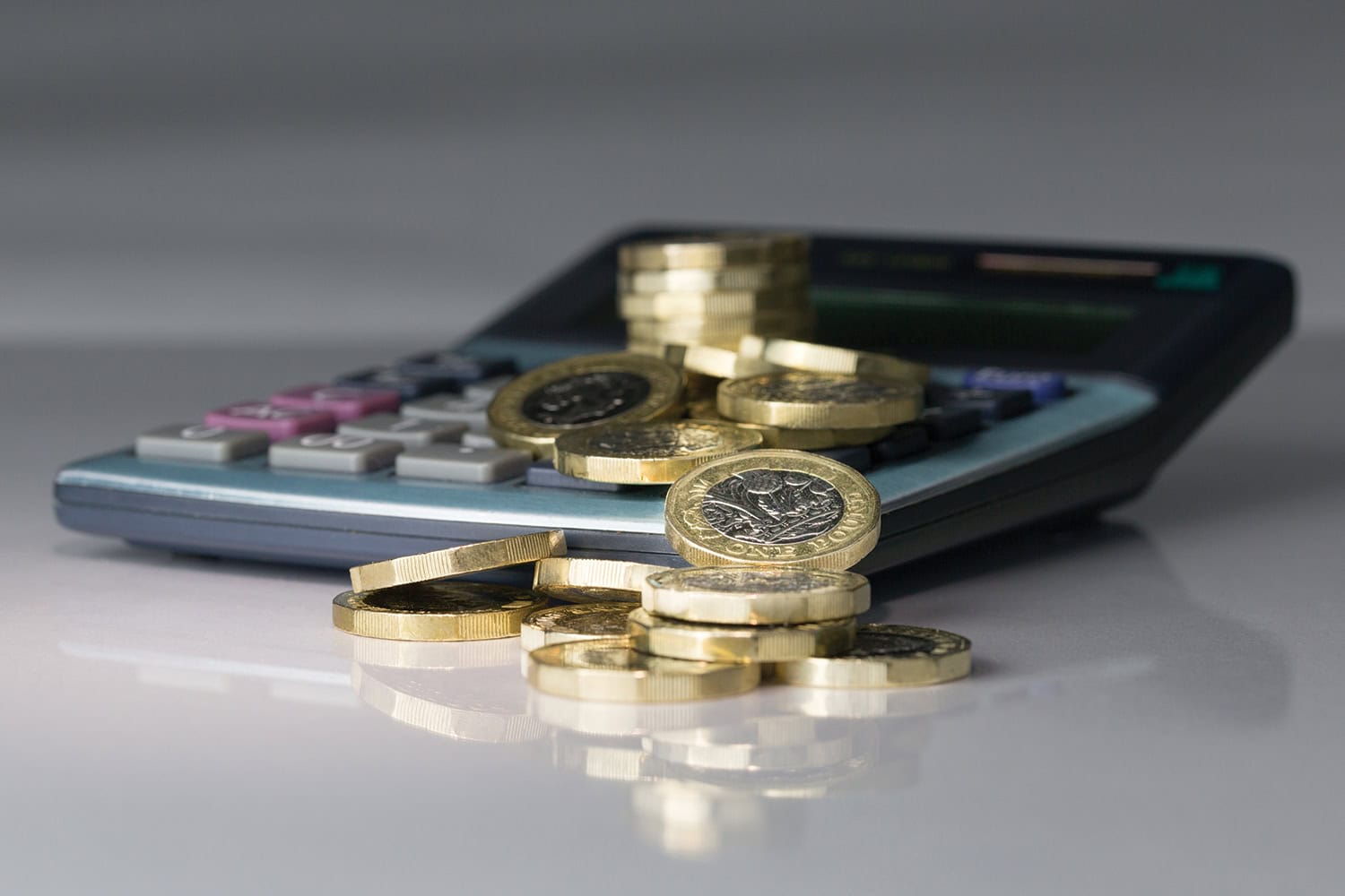 photo of pound coins spilling over a calculator