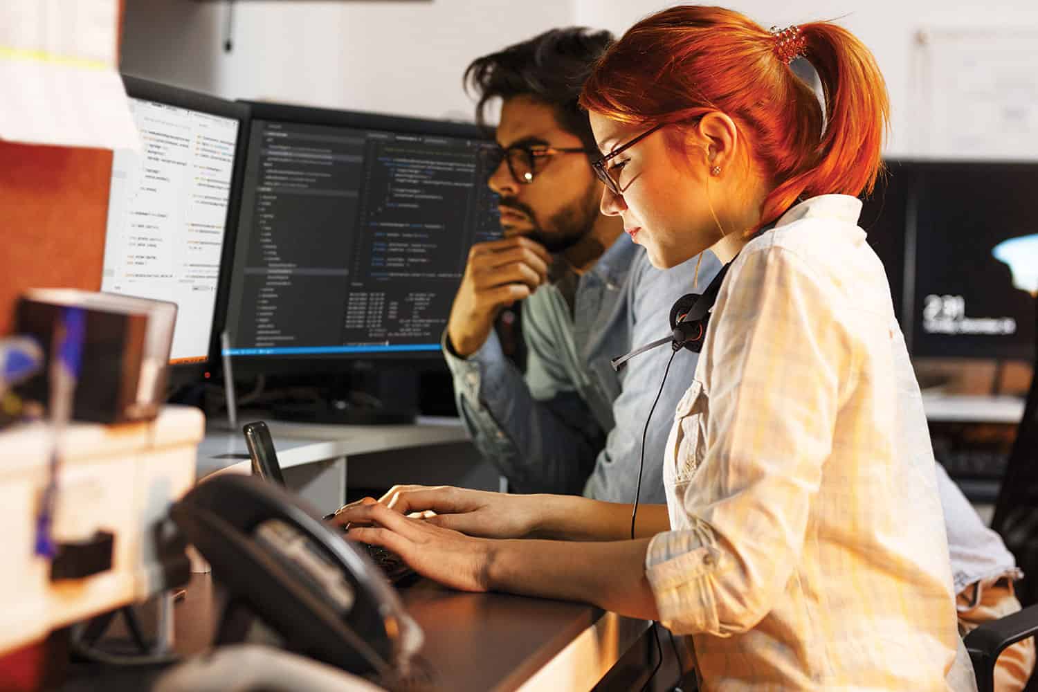 photo of male and female work colleagues looking at computer screens