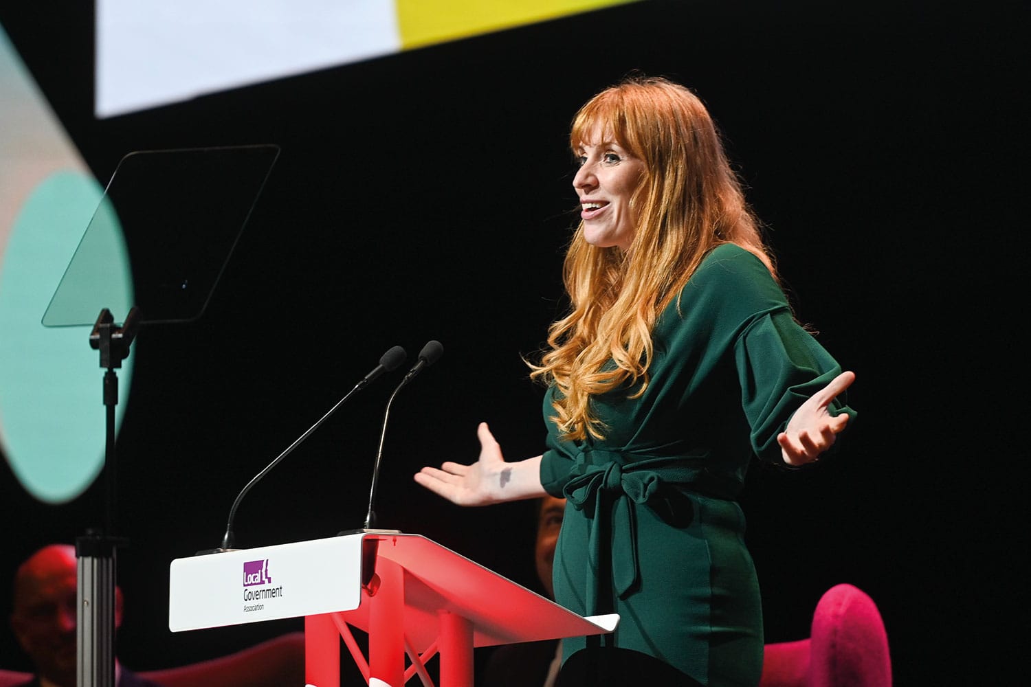 photo of Deputy Prime Minister Angela Rayner with arms outstretched and smiling, speaking at the LGA’s 2023 annual conference in Bournemouth.