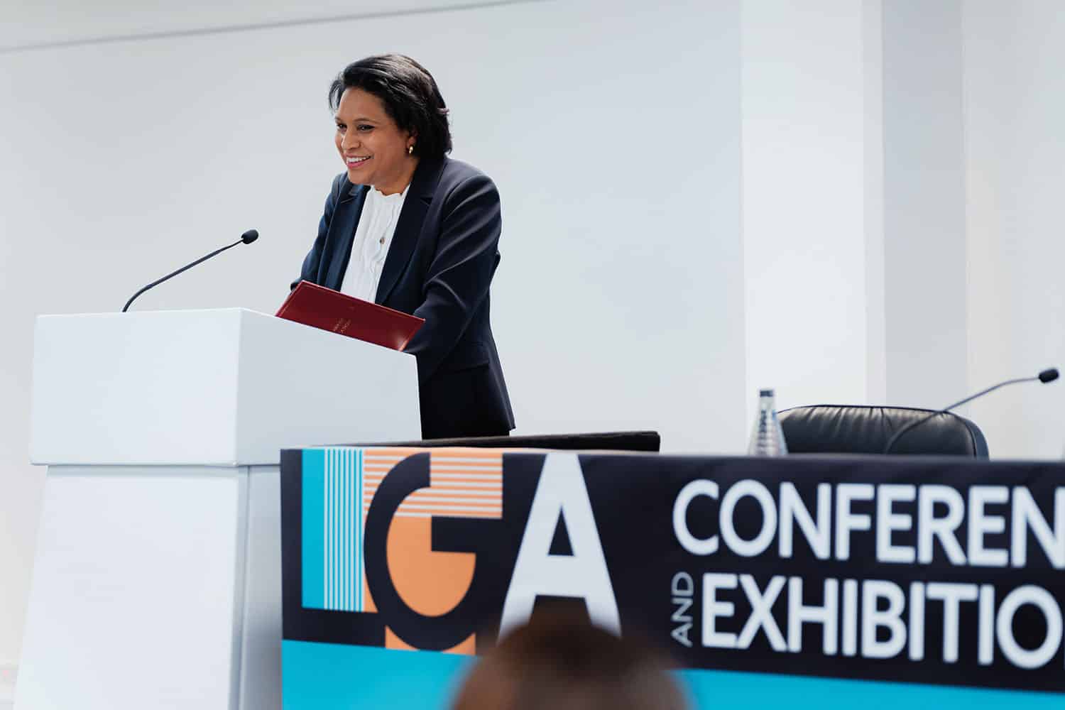 Children’s Minister Janet Daby standing up and smiling during her speech at LGA annual conference