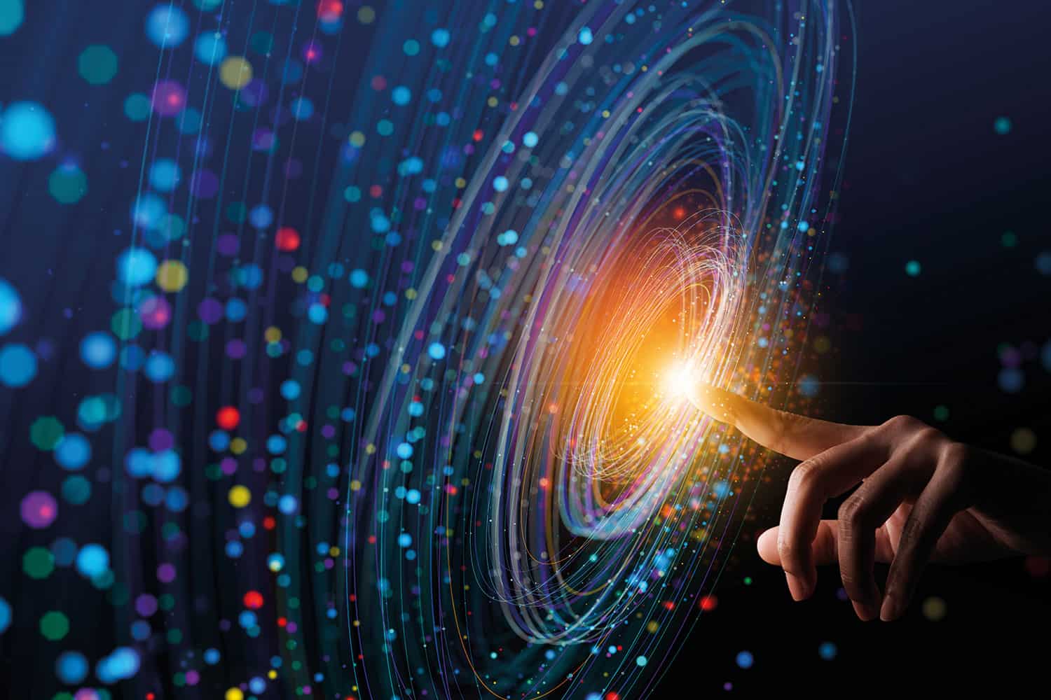 photo-graphic of hand with one finger pointing and at the centre of a circle of spiralling coloured lines and blogs of light symbolising digital data